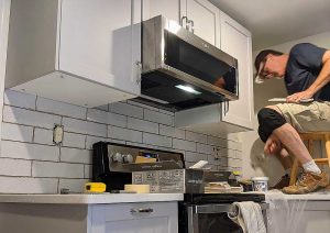 Handyman In The Loop at work tiling a kitchen